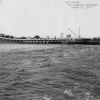 <p>Freight Pier after replacement of coal trestle with enclosed conveyor belt, looking southwest, August 1932. Two coal barges are moored at the end of the pier.</p>